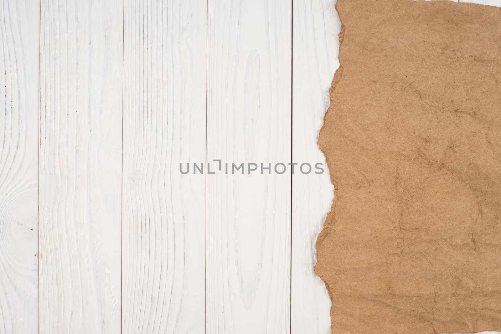 Crumpled paper on a white wooden background. Top view.