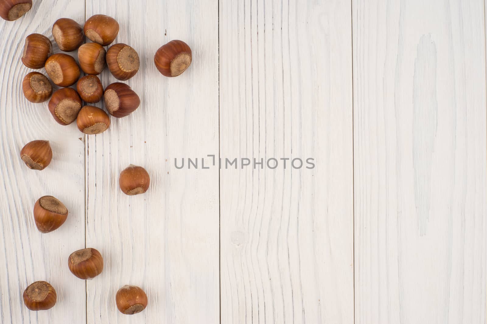 Hazelnuts on a old wooden table. Abstract background, empty template. Top view