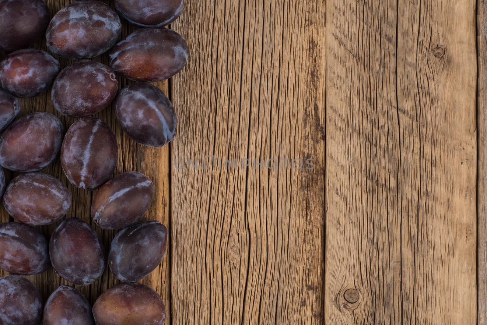 Plums on a wooden background. Top view.