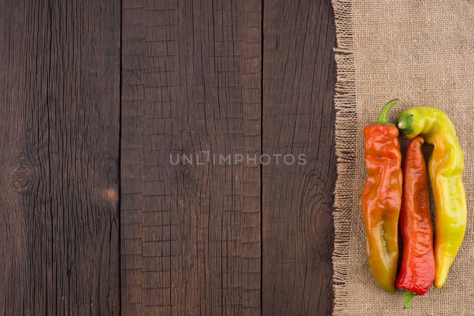 Hot peppers on old wooden table.  by DGolbay