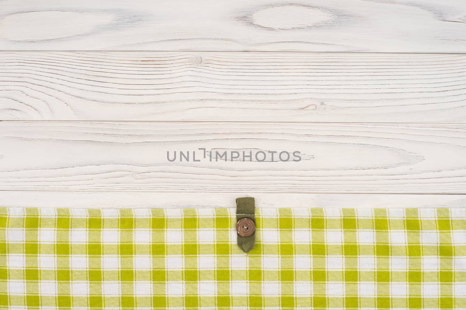 Kitchen cloth on old white wooden table.  by DGolbay