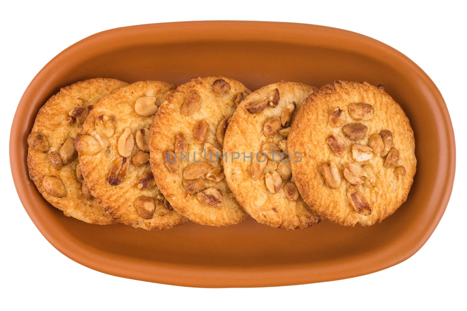 Peanut cookies in a brown plate. Isolated on white background.  by DGolbay