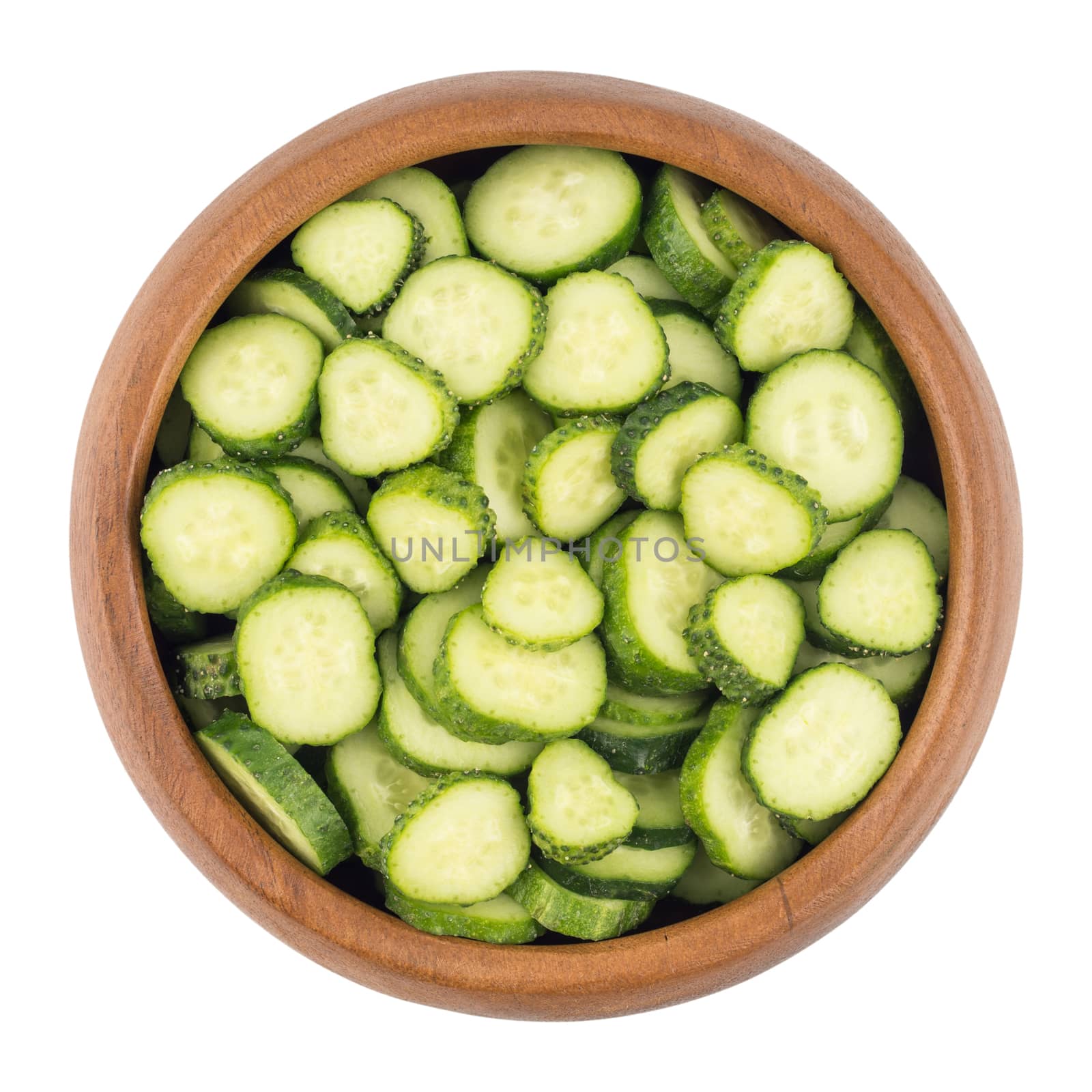  Fresh slice cucumber in wood bowl on white background by DGolbay
