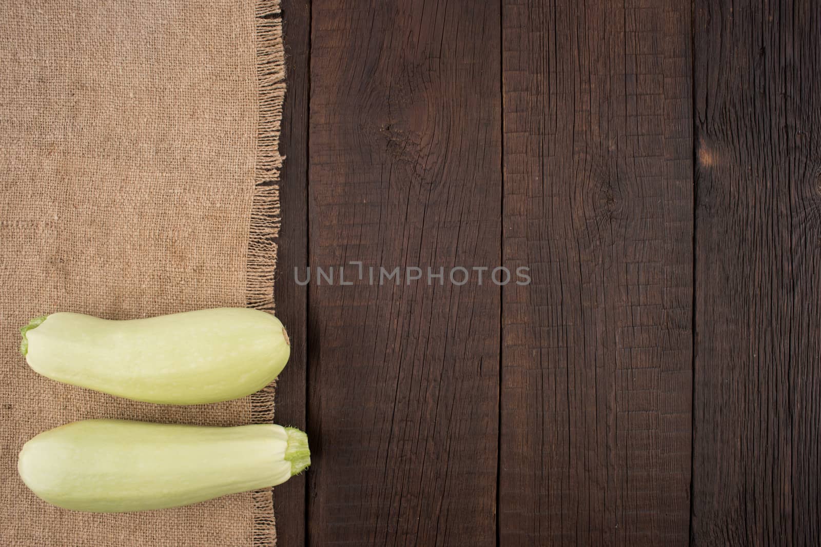 Zucchini on an old wooden table.  by DGolbay