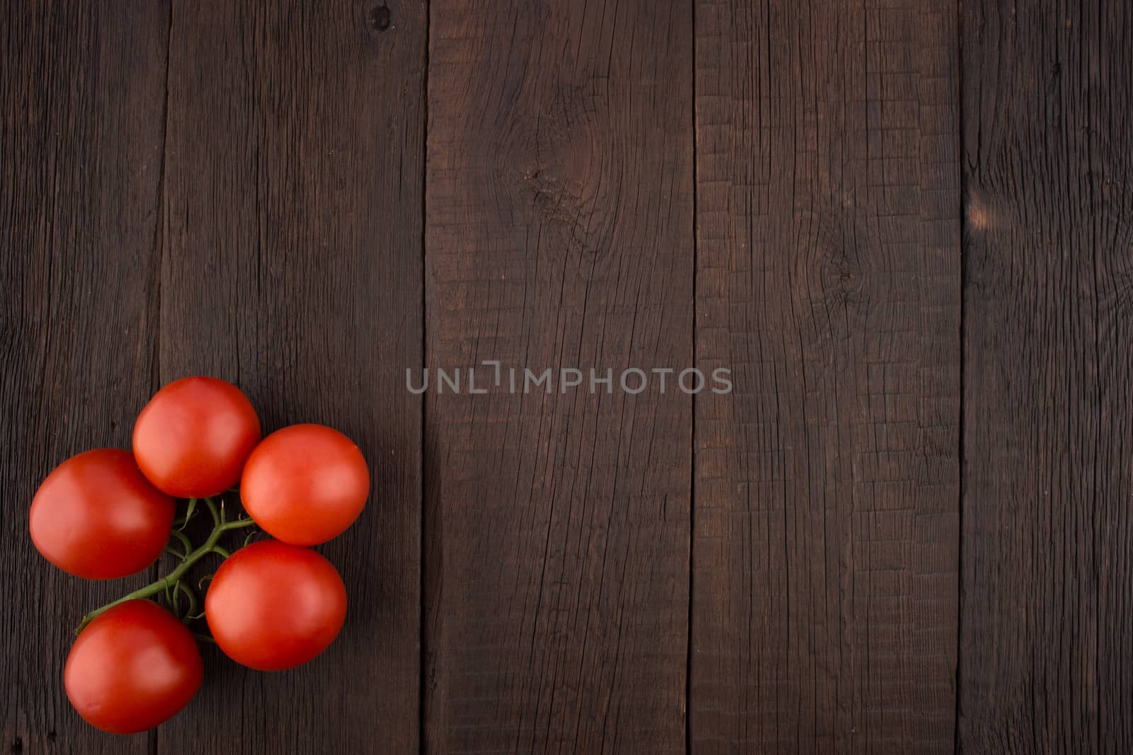 Tomatoes on old wooden table. Top view.