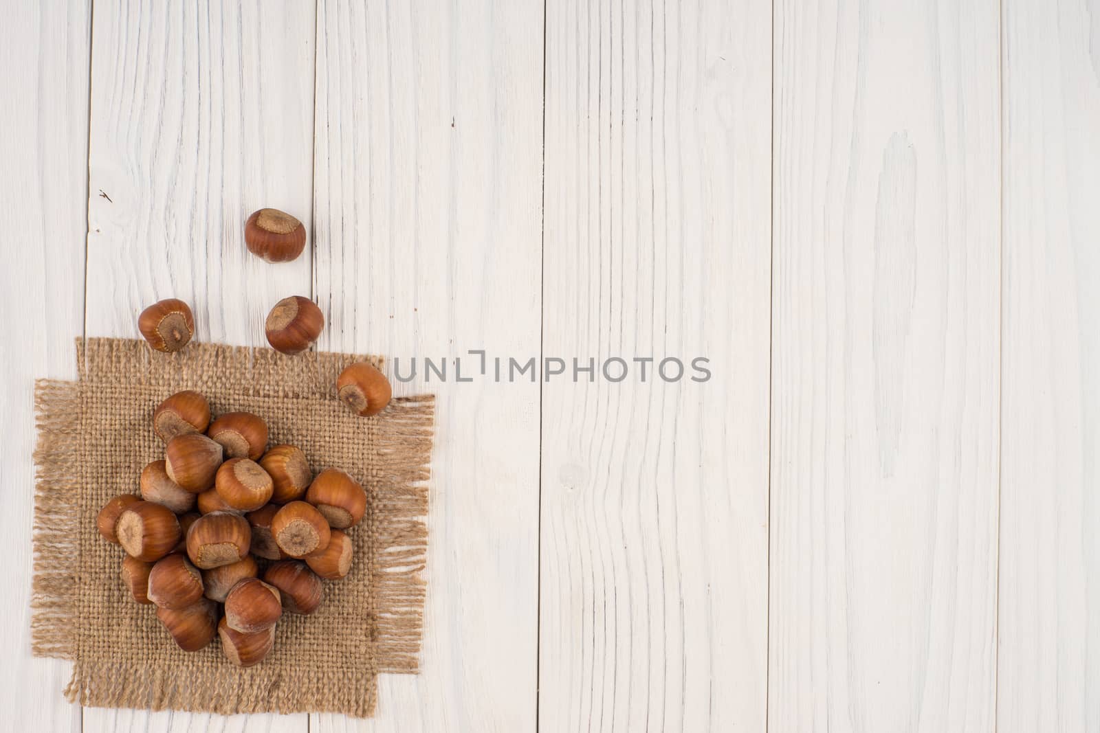 Hazelnut on sacking and an old wooden table. top view.