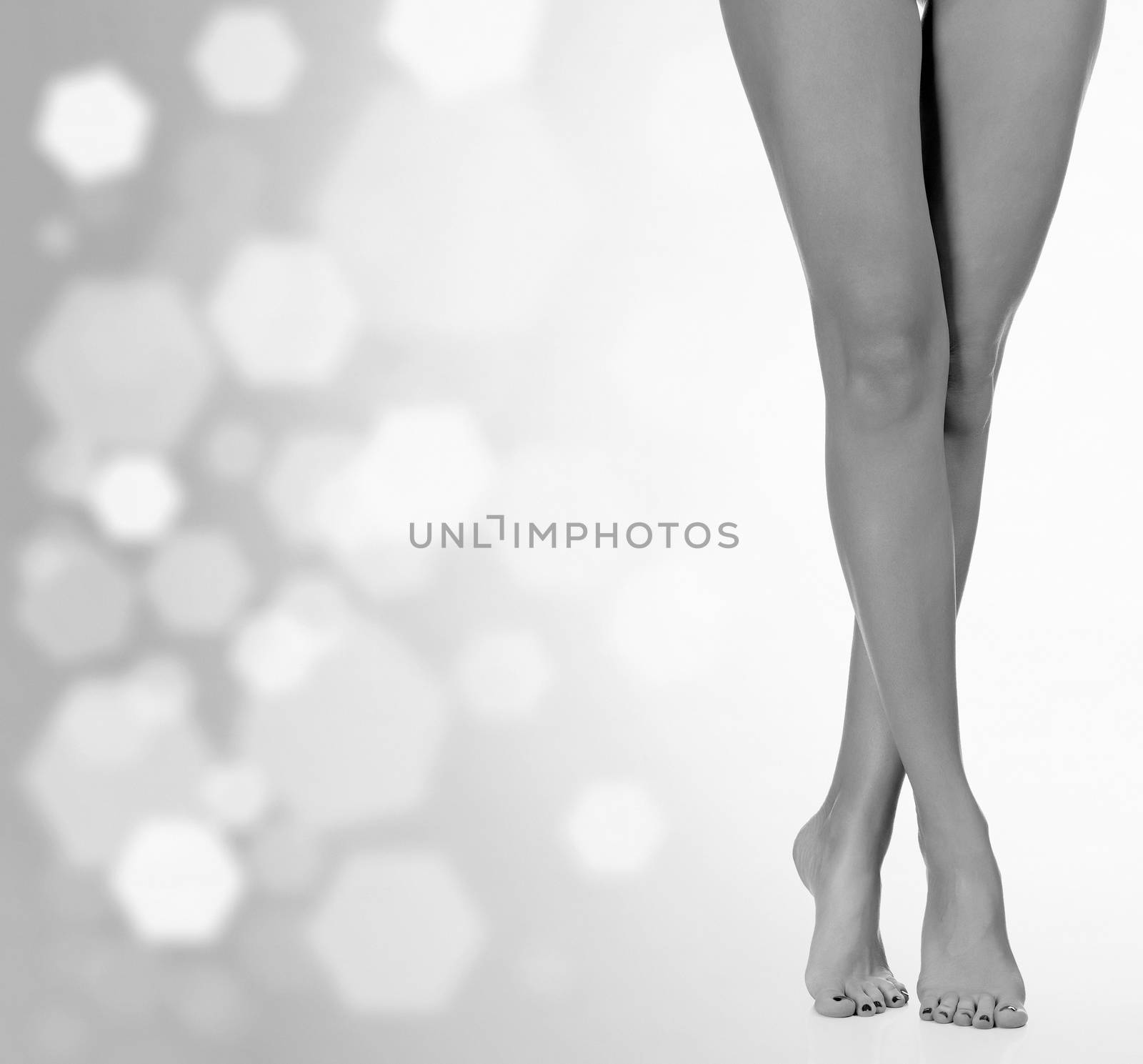 Long female legs after depilation, abstract blurred background by Nobilior