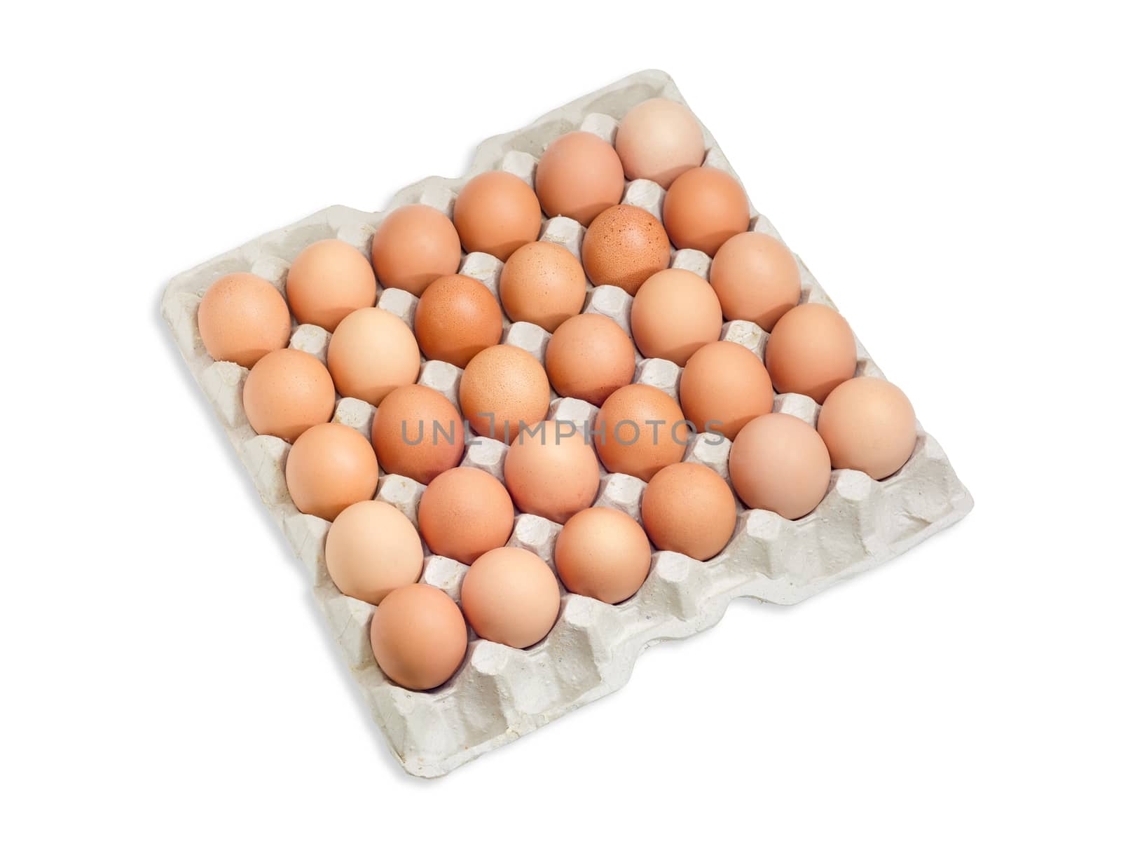 Top view of the cardboard egg tray with thirty brown and speckled chicken eggs on a light background
