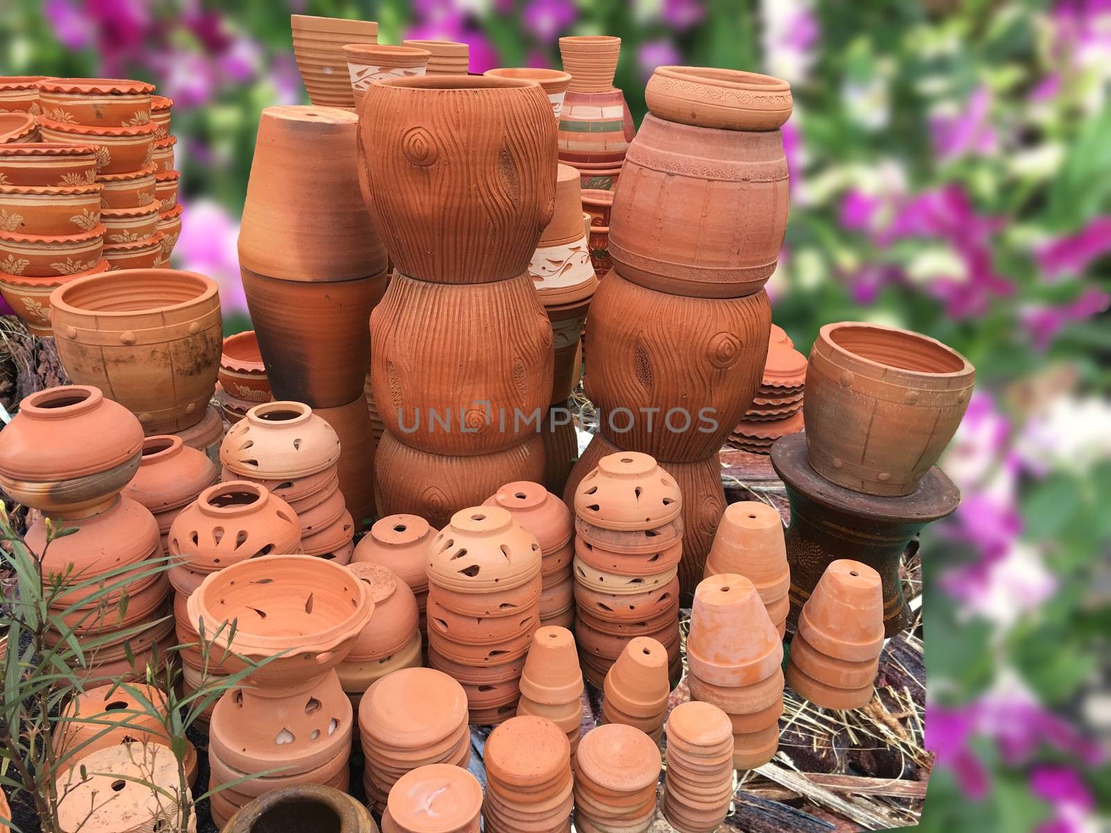 Handmaiden a ceramic flower pots. Flower shop with spring background and rustic flower pots.