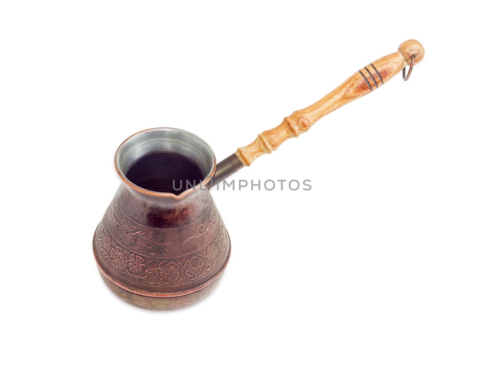 Empty old copper coffee pot with a wooden handle on a light background
