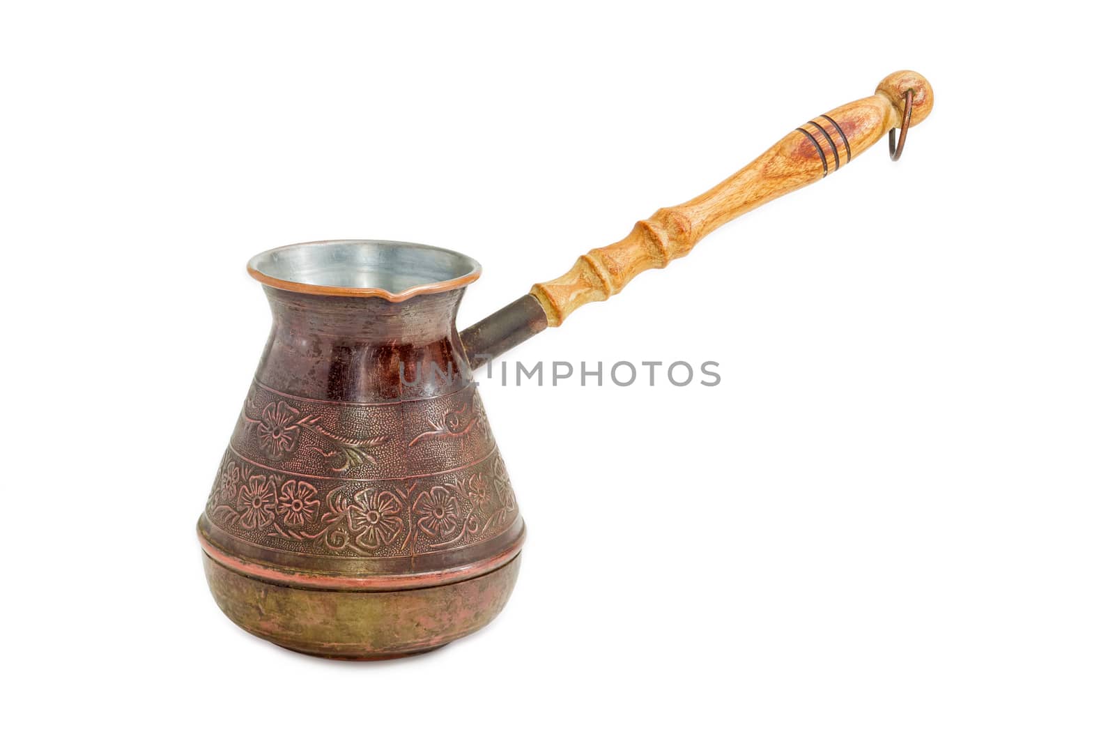 Old copper coffee pot with a wooden handle on a light background
