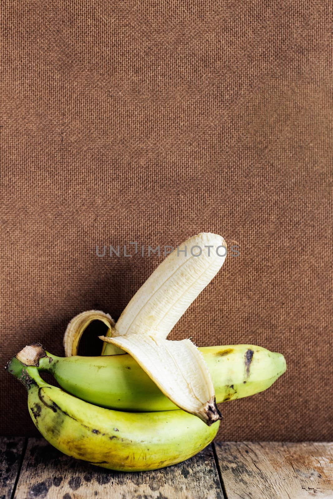 Banana on wooden floor. by start08