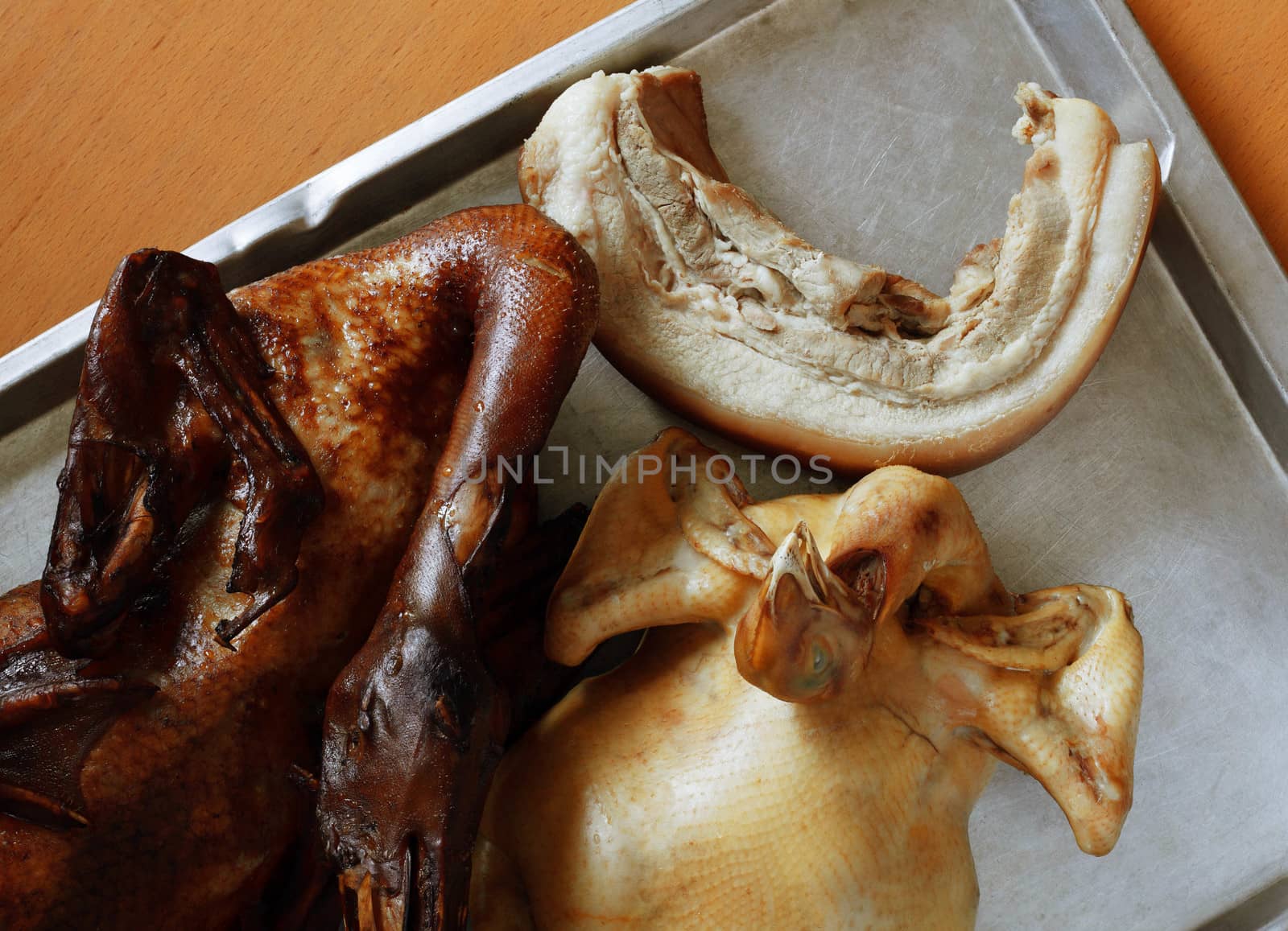 chicken and pork on the tray for cooking.