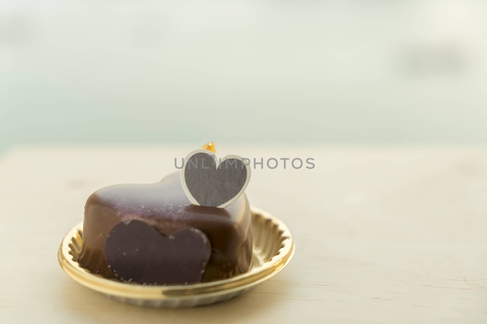 Fancy Heart shaped chocolate cake on a wooden table