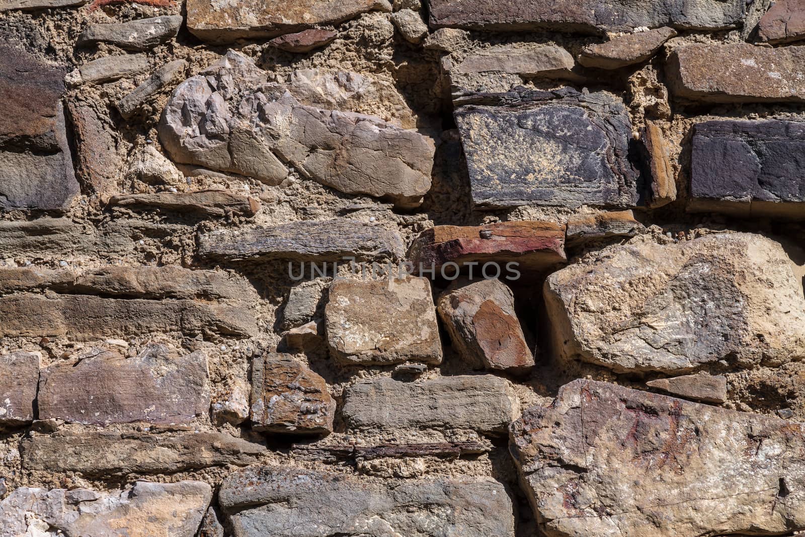 Part of an old stone wall with clay masonry