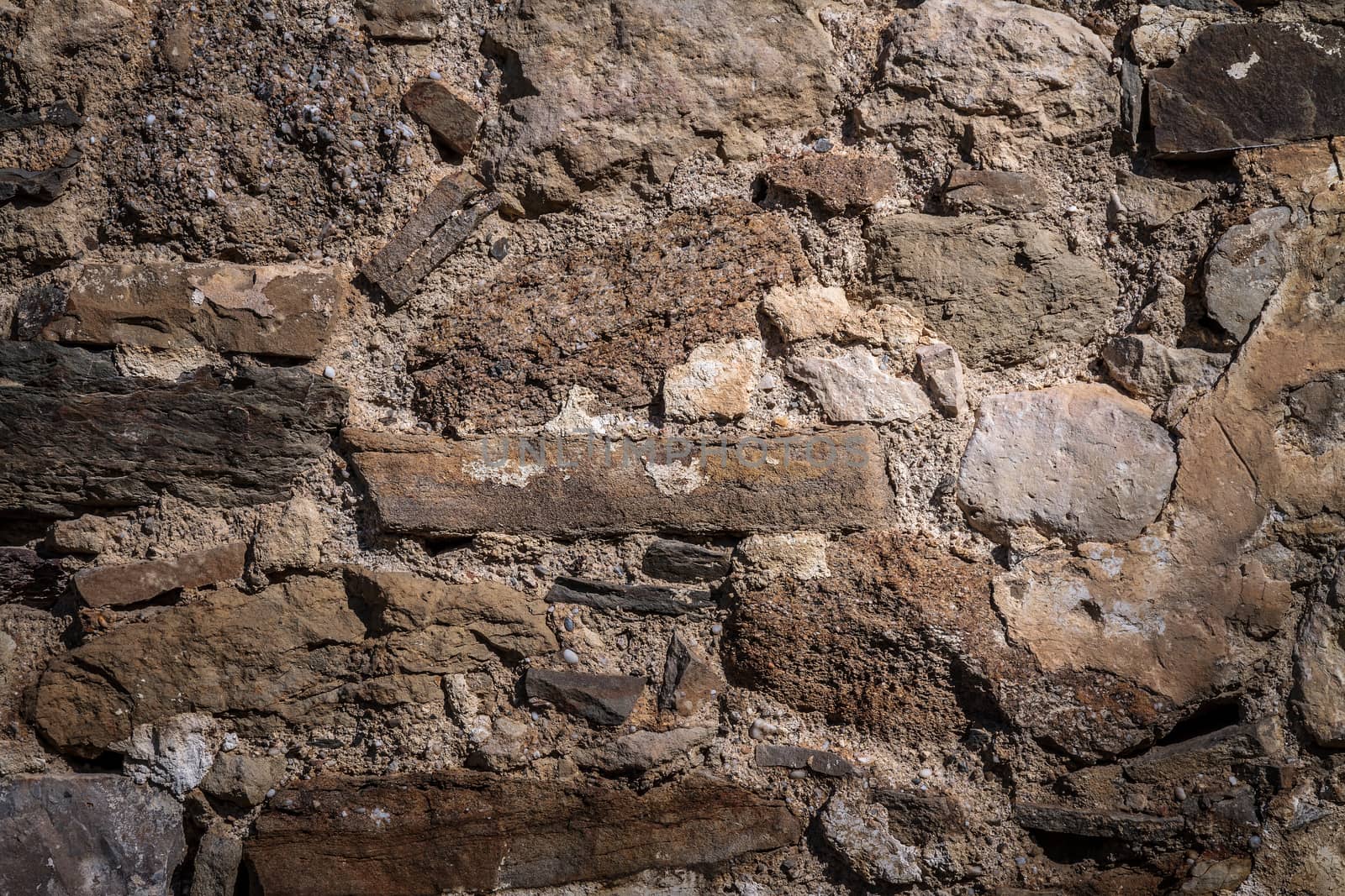 Part of an old stone wall with clay masonry