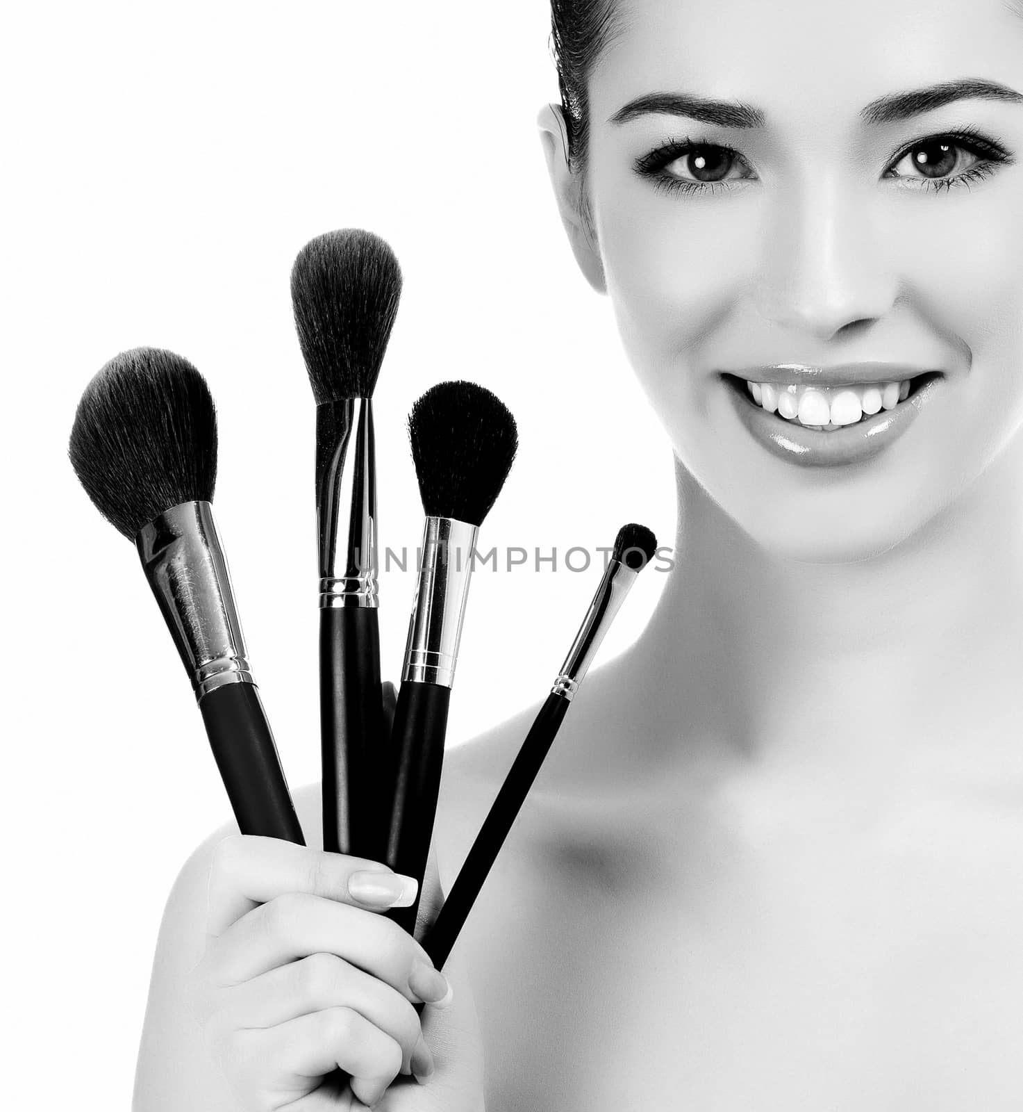 Female with cosmetic brushes, white background, copyspace