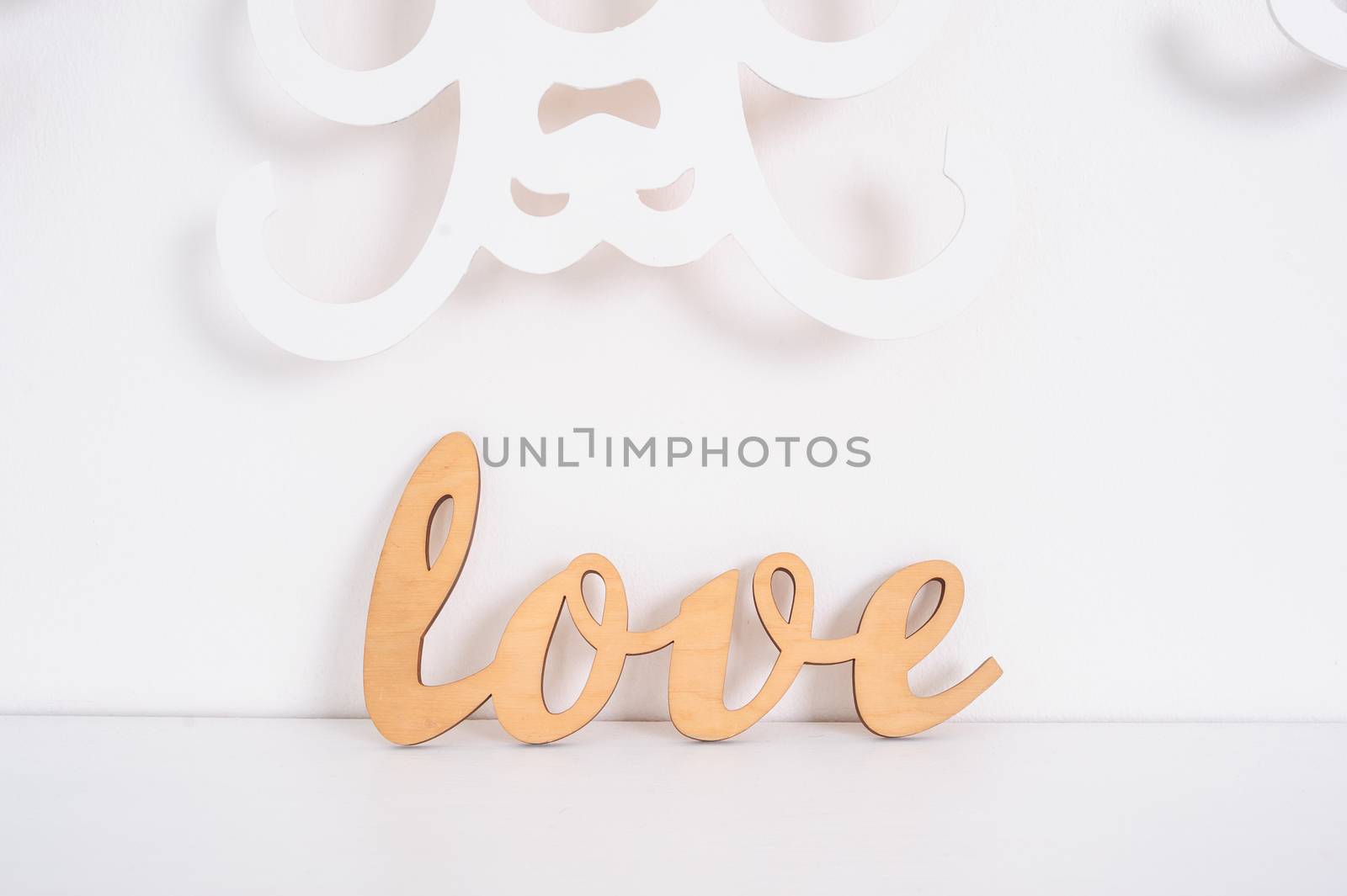 wooden word love on a white background in studio.