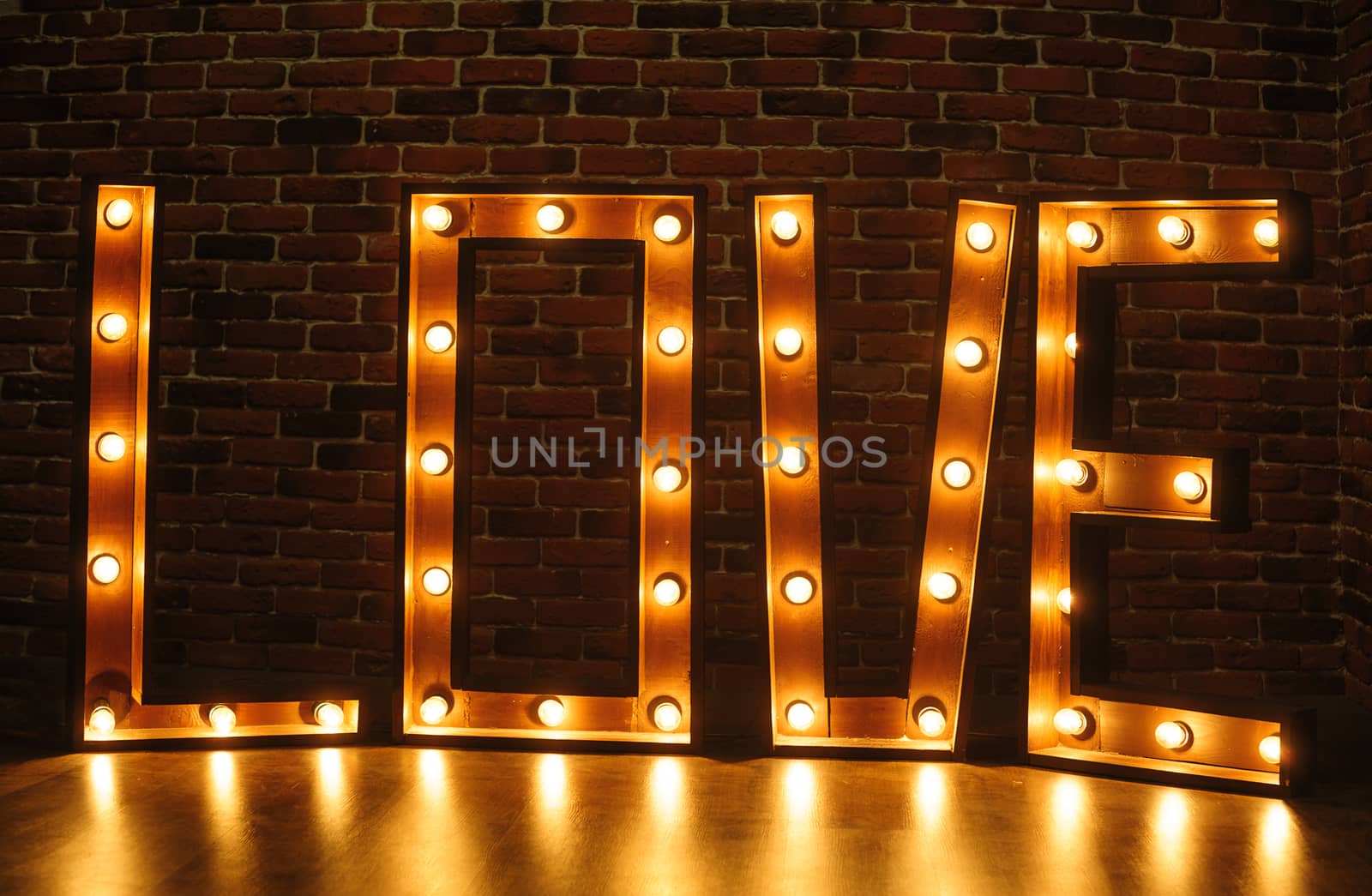 large wooden word love with lights in the studio