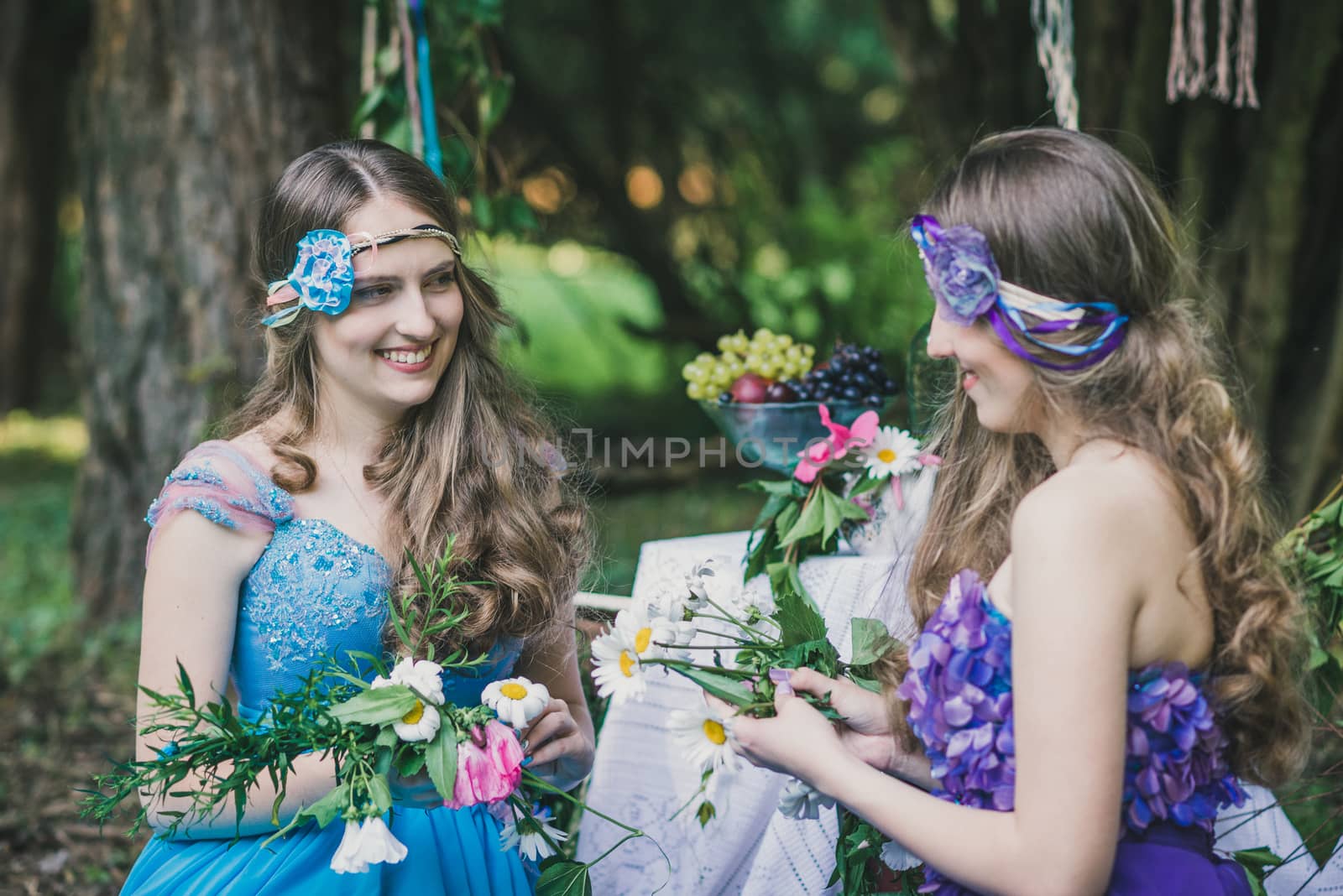 two adult sisters are twins with flowers in the garden