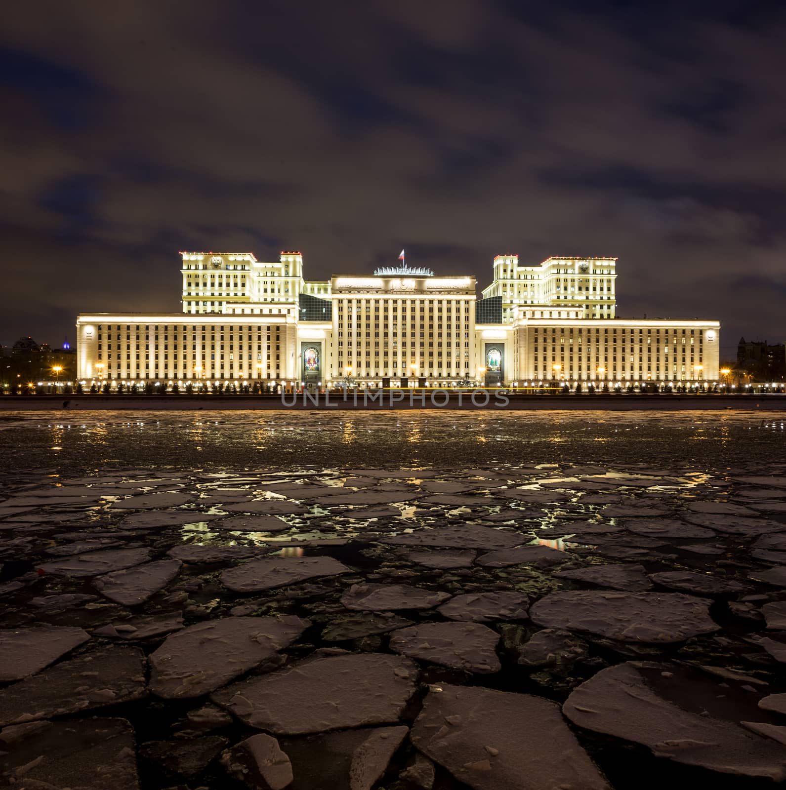 Russian Ministry of Defense in the evening in winter. On the foreground is Moscow River covered by ice floes. by straannick