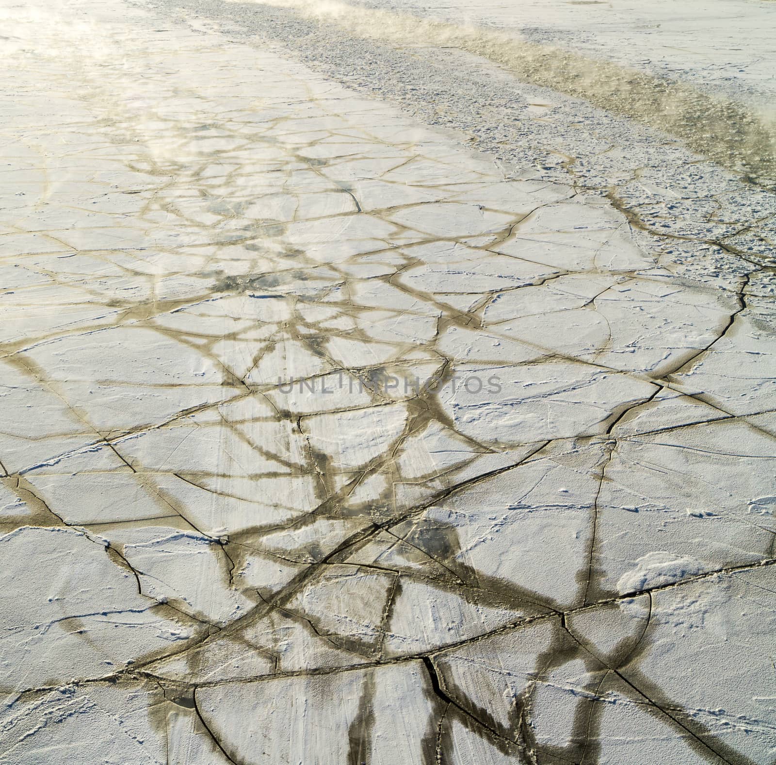 Frozen, covered with ice floes Moskva River, back lit photo by straannick