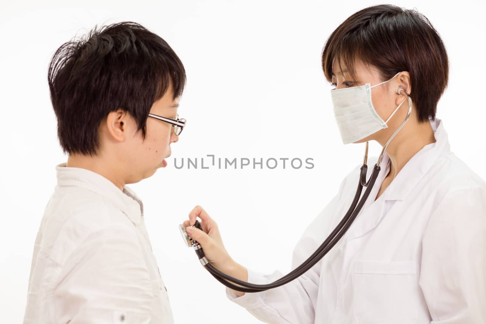Chinese female doctor checking patient's heart with stethoscope