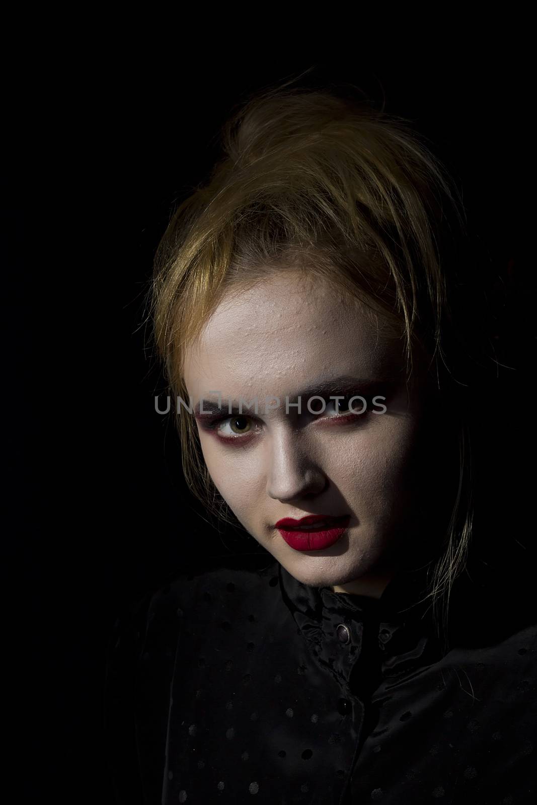 Young girl vampire on a black background