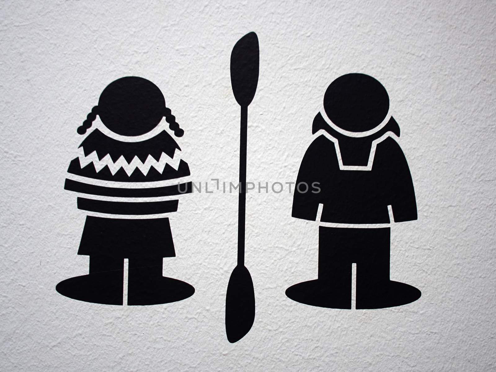 Graphic symbol icon of an Eskimo couple man an d woman in traditional clothing