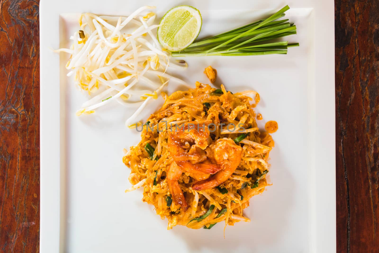 top view Thai fried noodle with fresh prawn on white dish