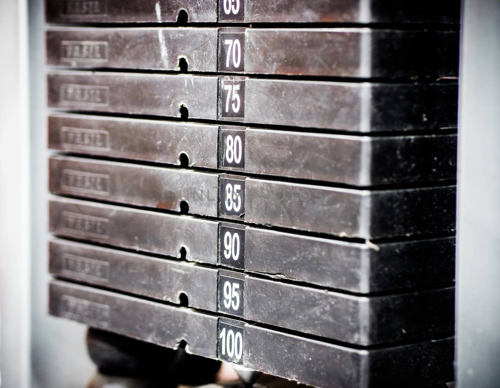Stack of rusty metal weights in gym bodybuilding equipment by fascinadora