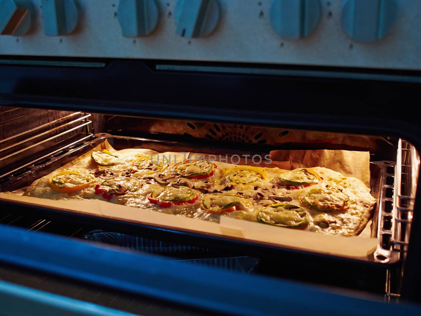 Tasty fresh traditional Italian vegetarian pizza being baked in the oven