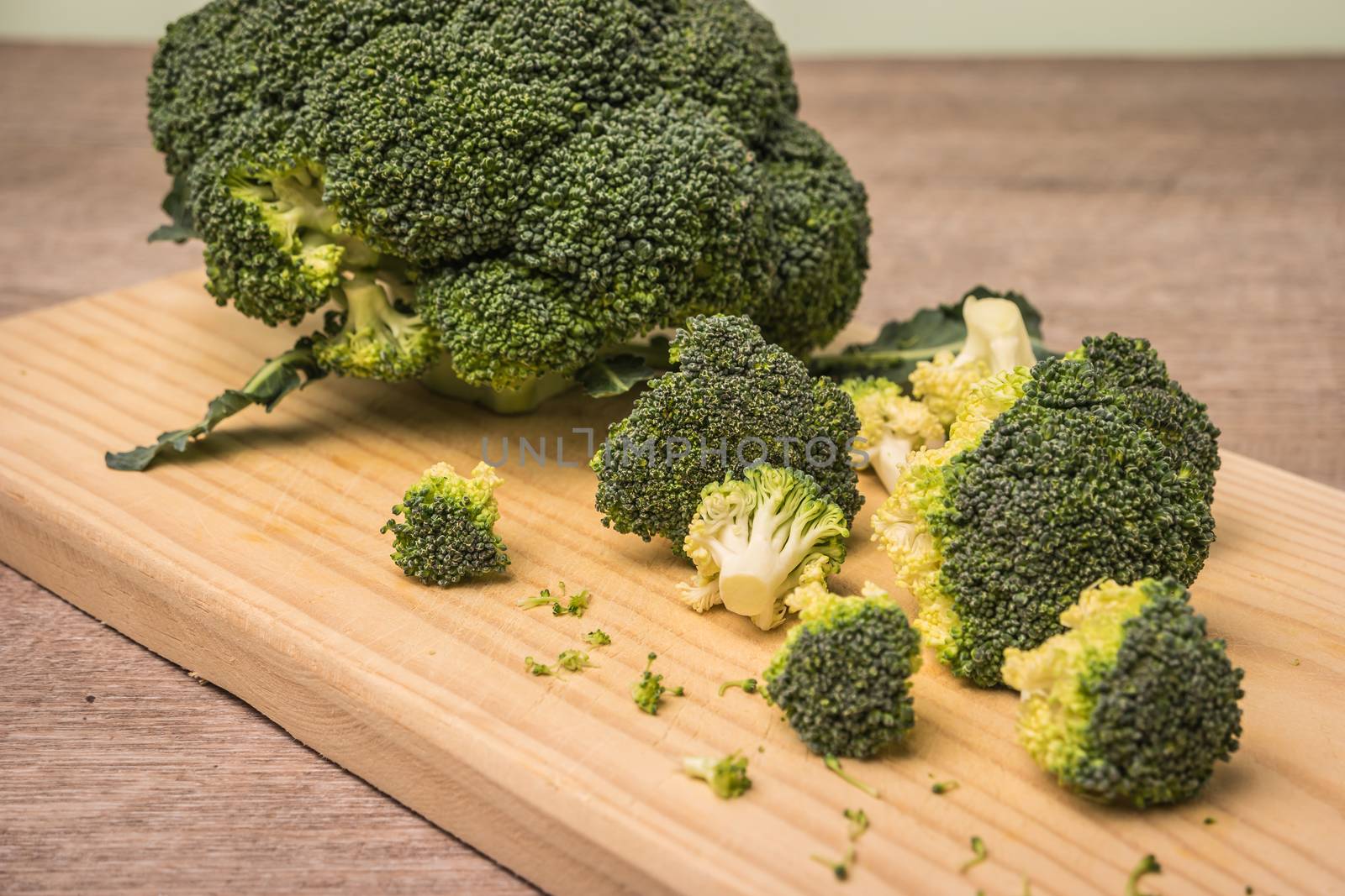 Fresh broccoli with spinach on wooden table close up by AnaMarques