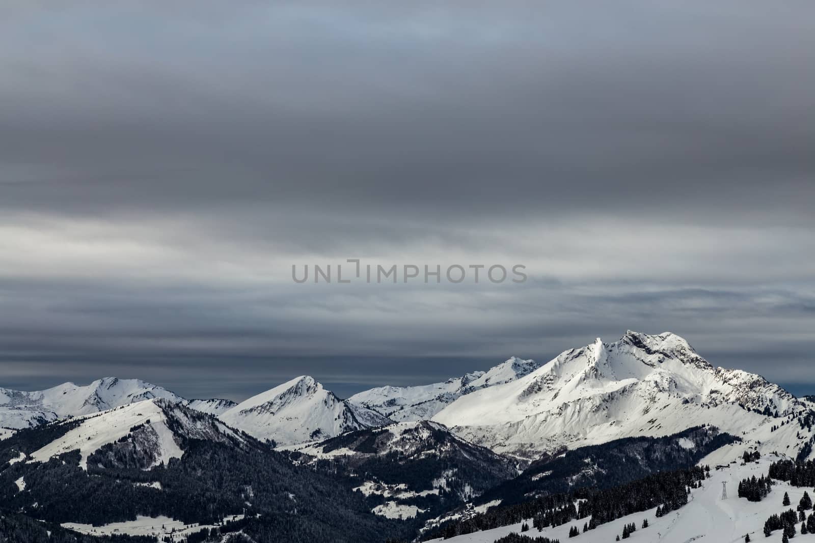 Mountains covered with snow and surrounded by clouds by kenzo85