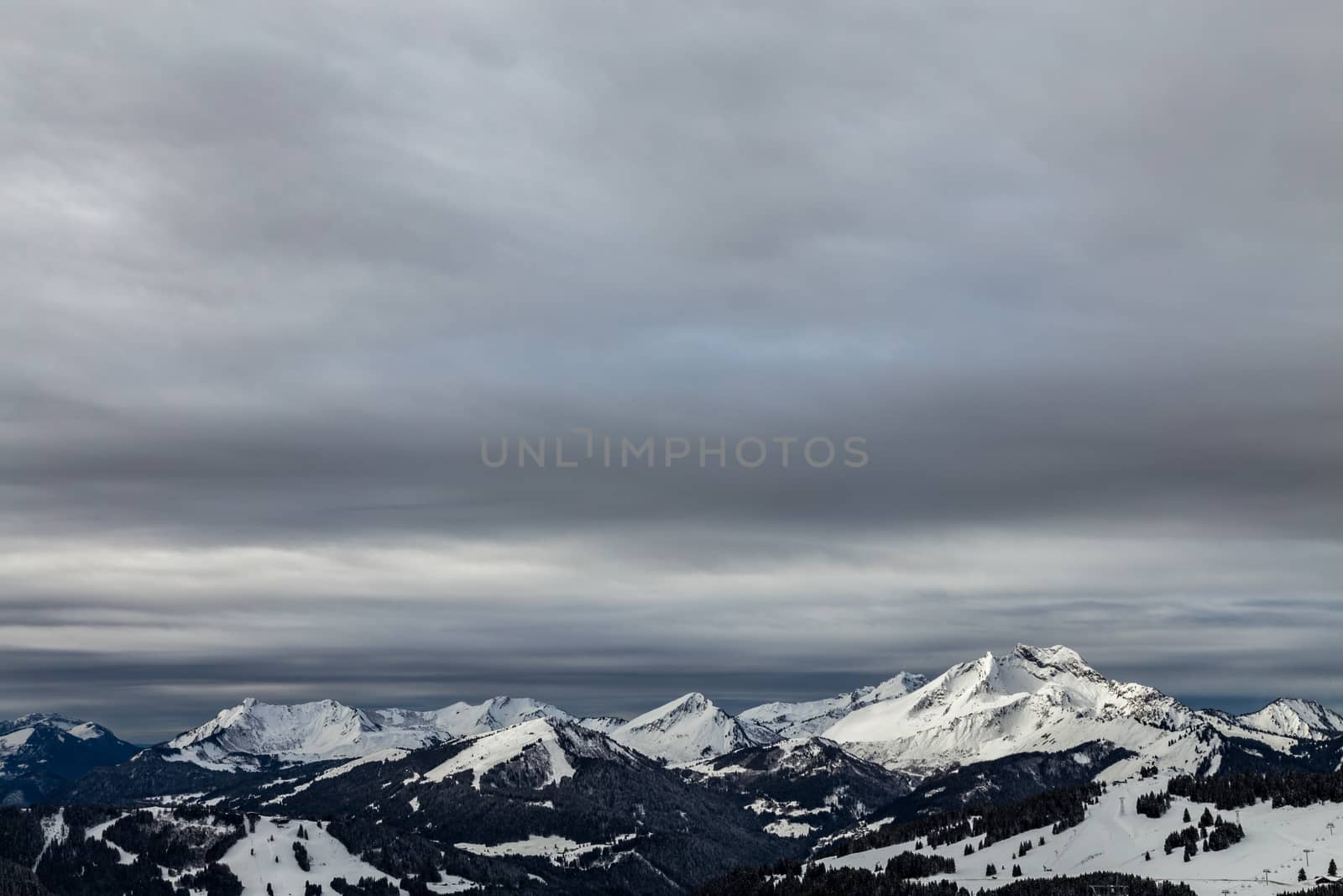 Mountains covered with snow and surrounded by clouds in the Alps