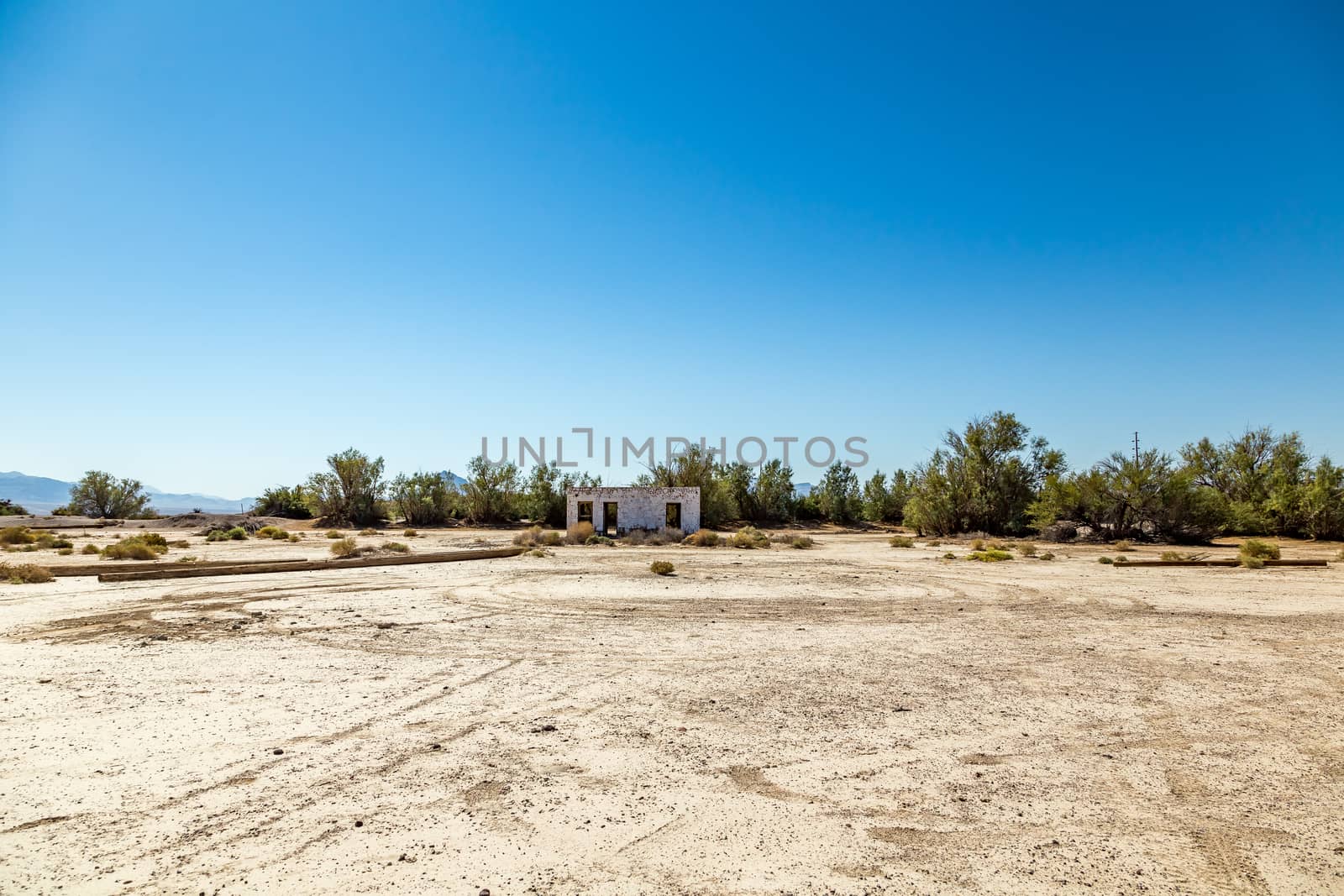 An abandoned building sits alongside the roadway near Death Valley Junction in the Funeral Mountains Wilderness Area, California.