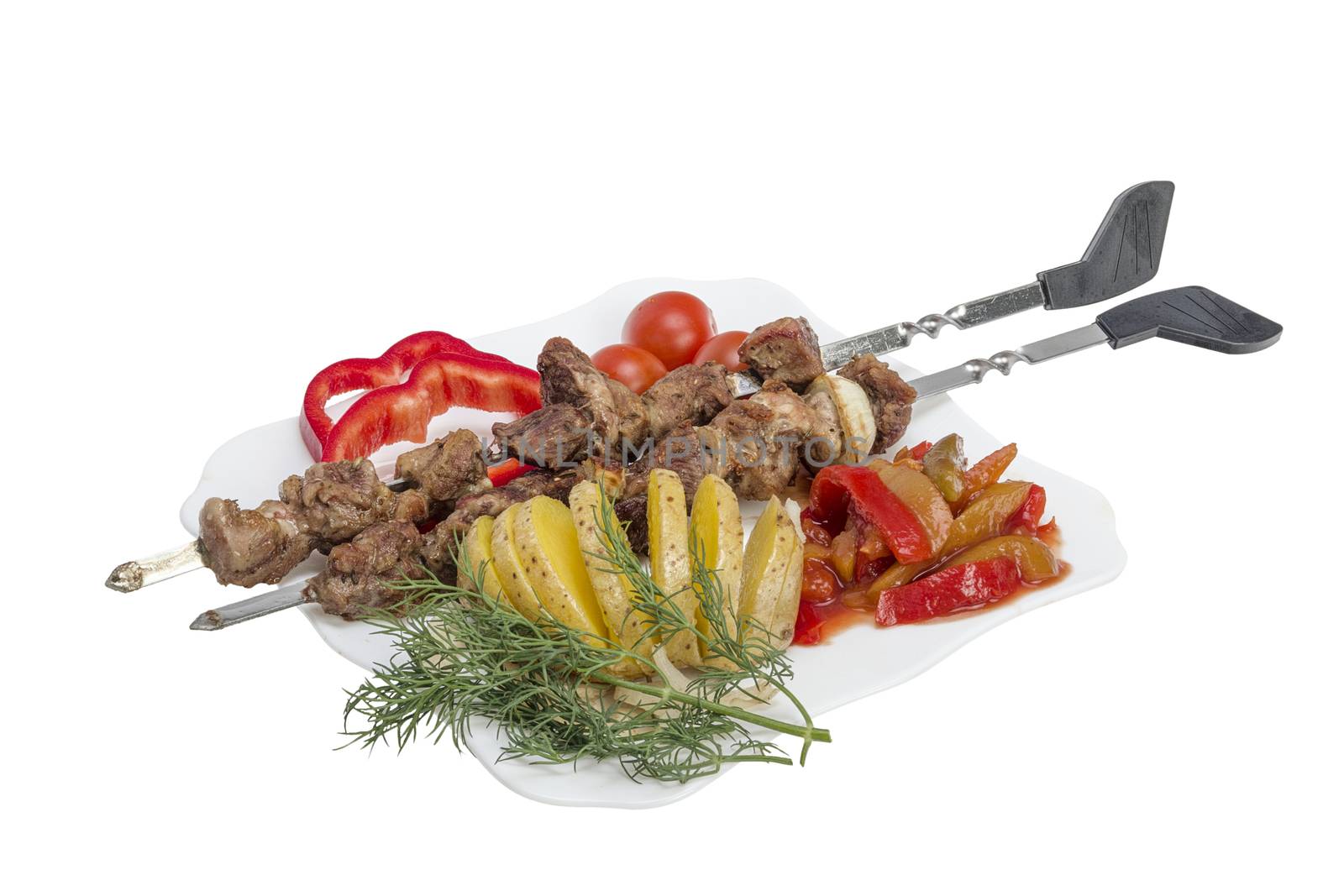 Kebabs grilled meat tomatoes and vegetables on white background 