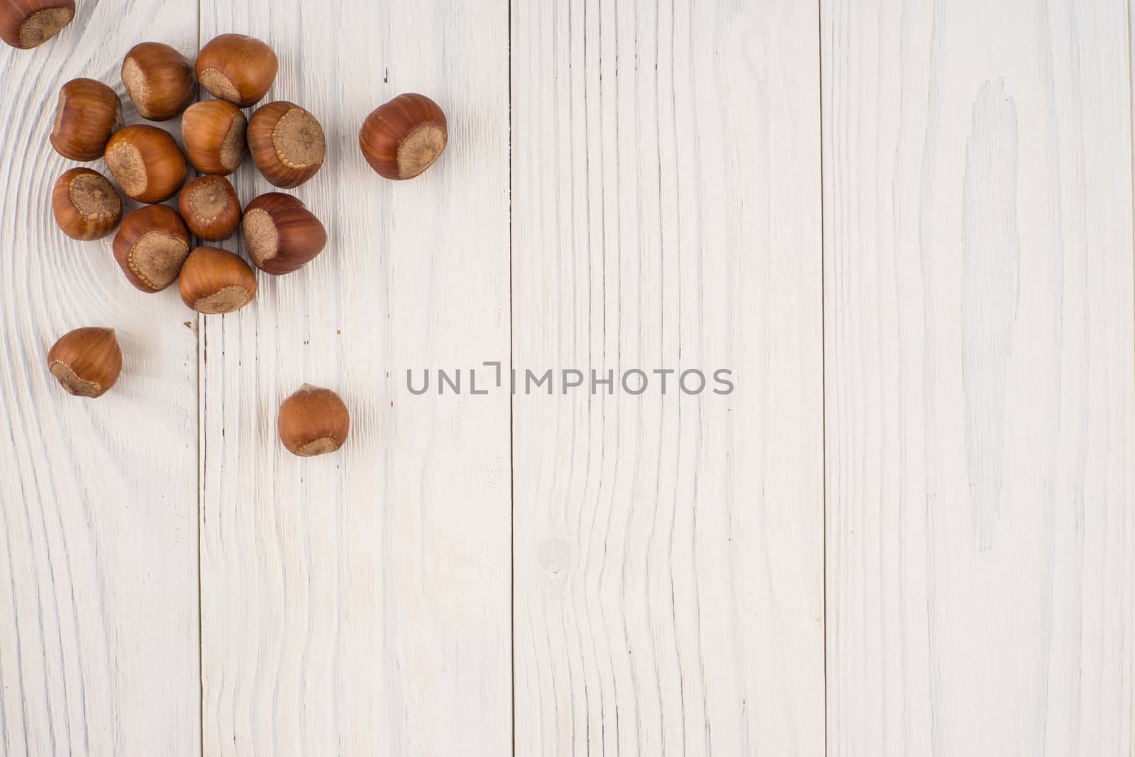 Hazelnuts on a old wooden table.  by DGolbay