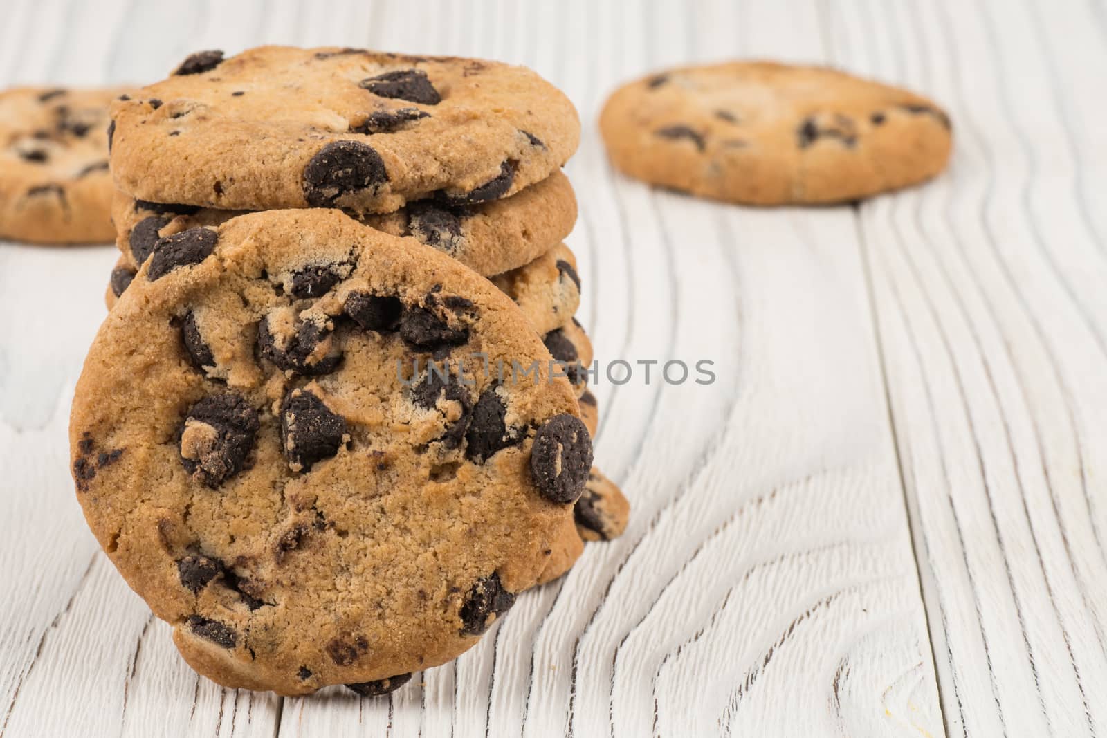 Chocolate cookies closeup on white old wooden table. by DGolbay