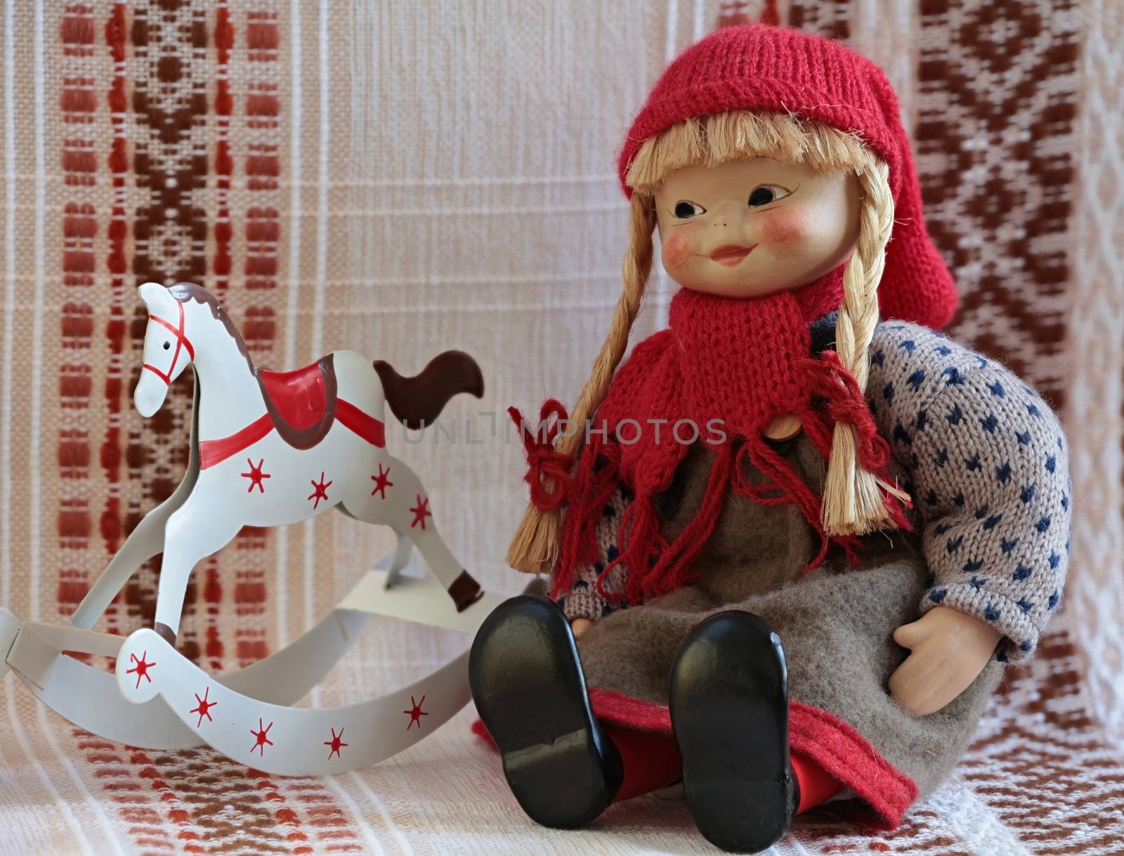 puppet sitting beside rocking horse 