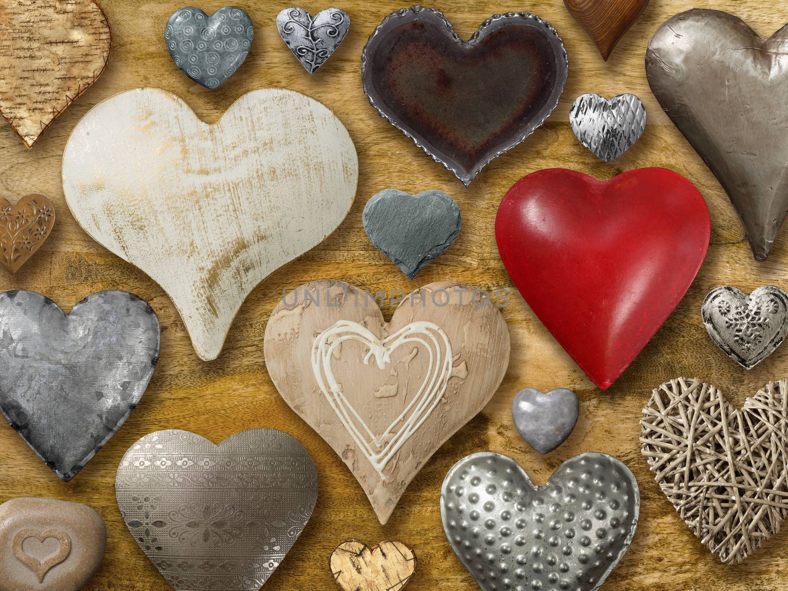 Photos of many heart-shaped things made of stone, metal and wood on wood background.