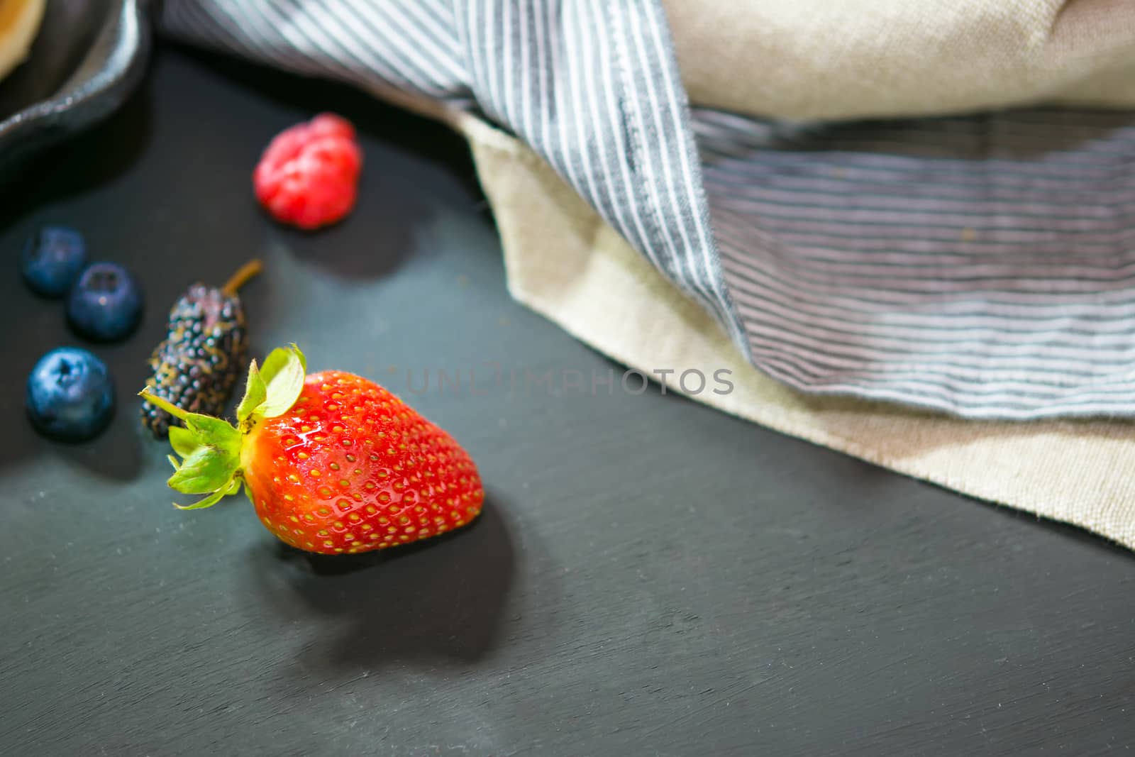 Selective focus strawberry on wood background  by ahimaone