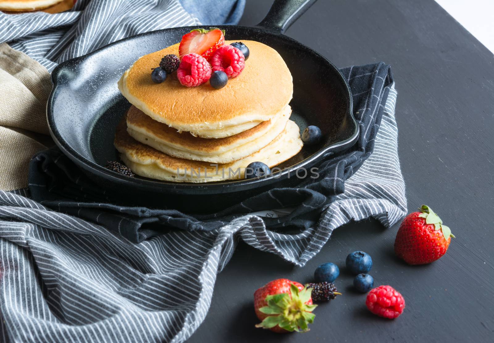 Selective focus Pancakes with blueberries  & raspberry on wood background