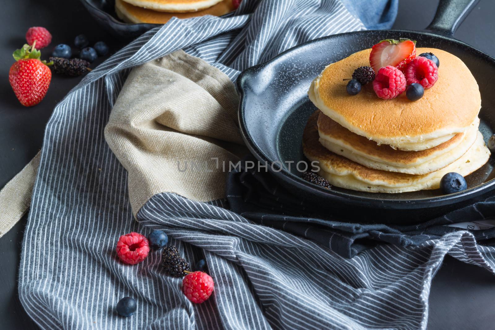 Pancakes with blueberries  & raspberry on wood background  by ahimaone