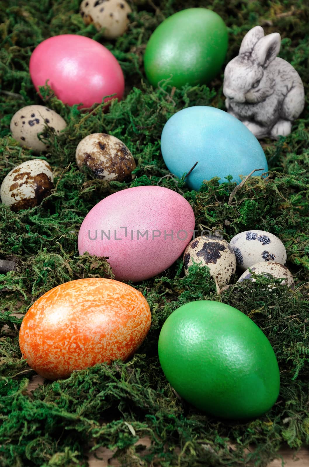 Easter colored eggs scattered on a green moss as an element of a holiday decoration ideas