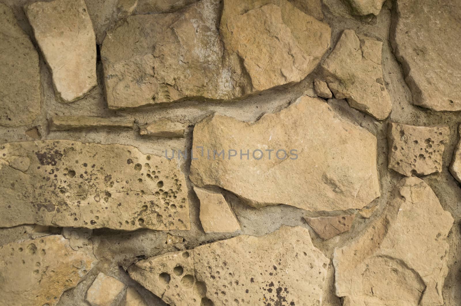 Old random limestone stone wall with mortar background by Sublimage