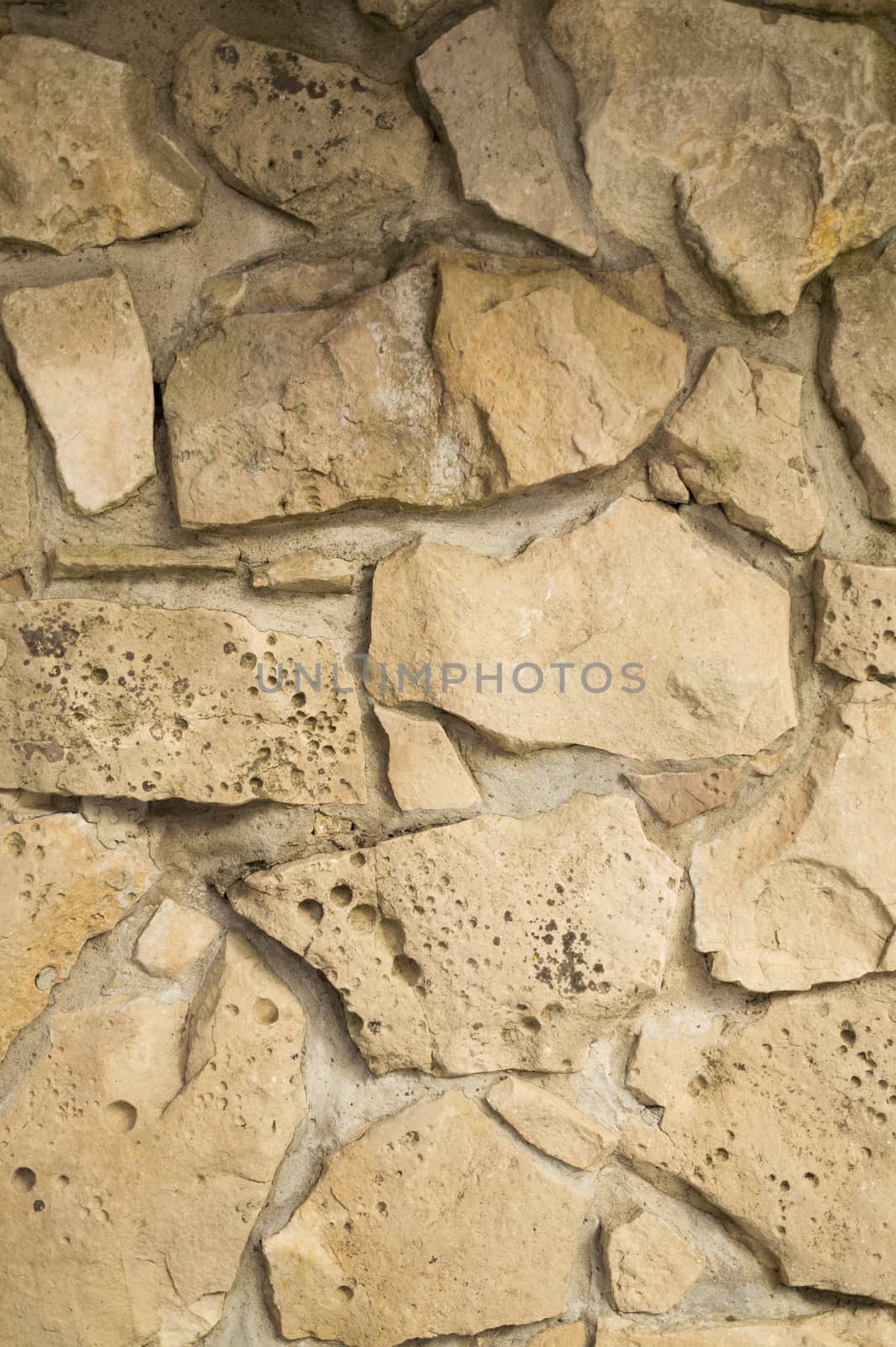 Old random limestone stone wall with mortar background by Sublimage
