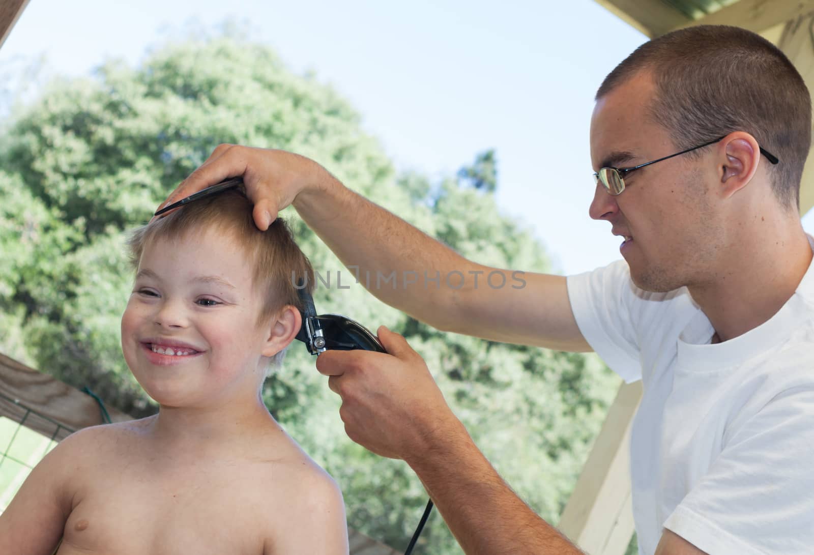 Cute Little Boy With Downs Syndrome Geting His Haircut