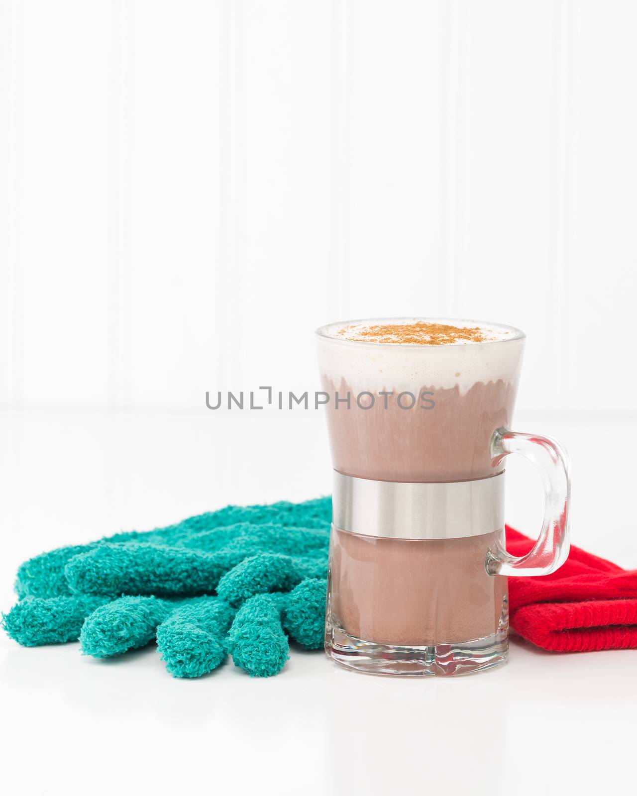 Cup of creamy hot chocolate with whipped cream and cinnamon.