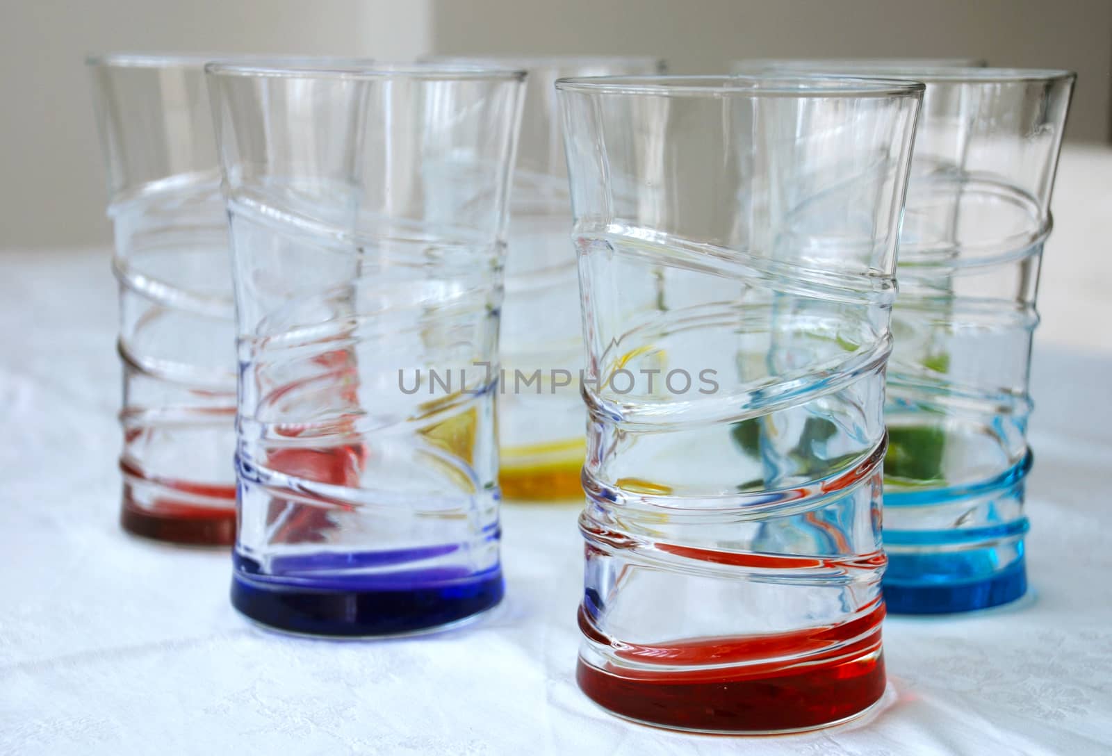 six brightly colored beverage glasses